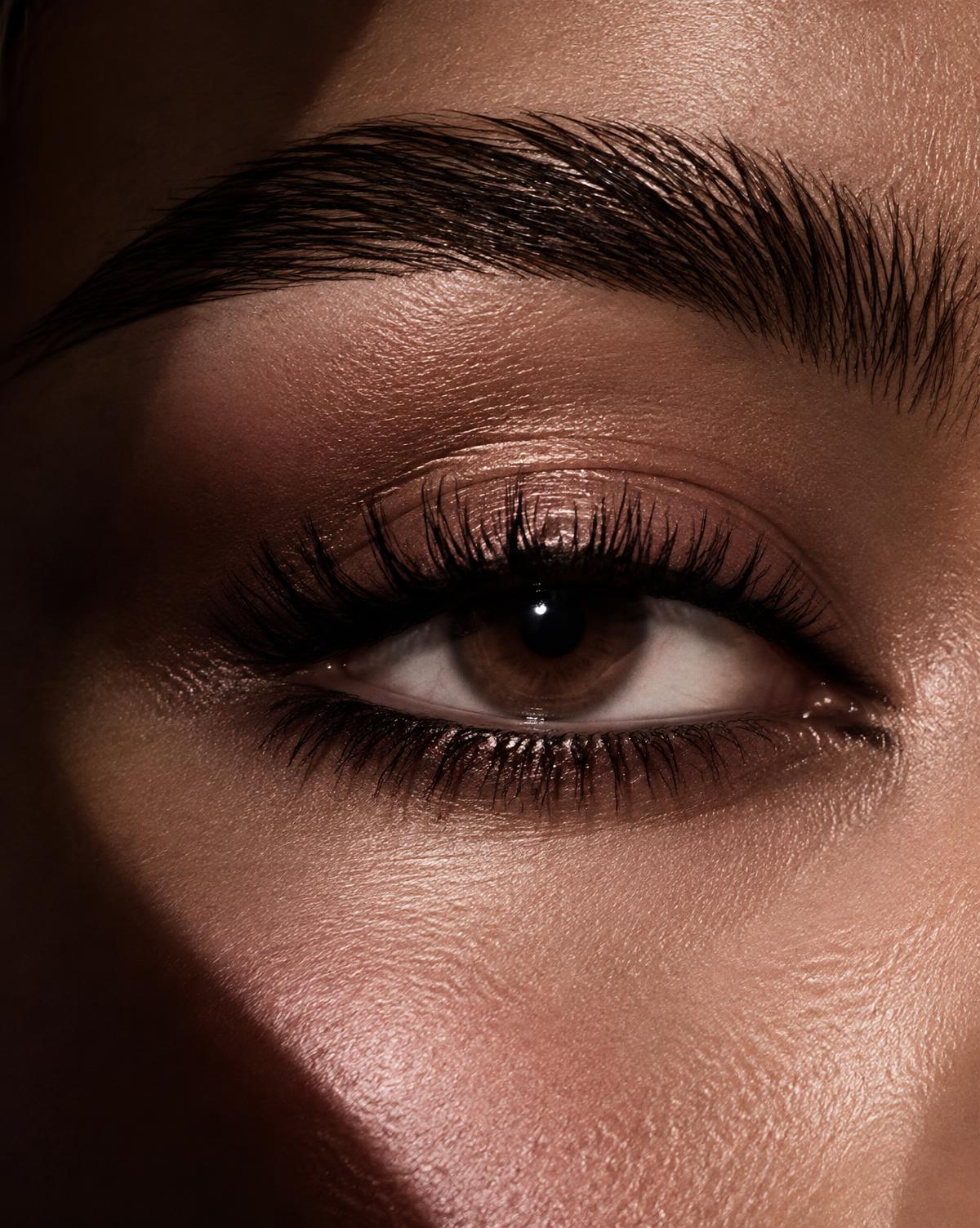 Glossy lifted lashes and a sculpted laminated brow